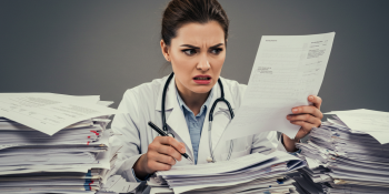 Doctor surrounded by case notes